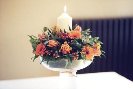 Wedding tables had centrepieces with rich warm flowers and candles