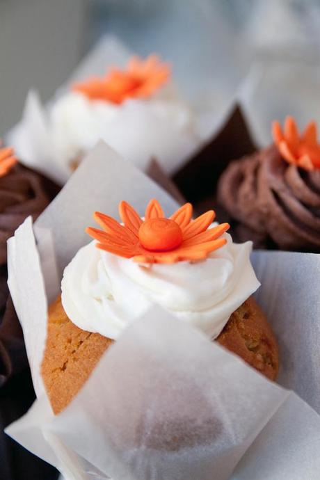 Yummy wedding cupcakes with bright orange flowers