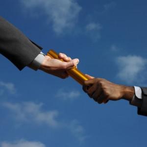 Businessmen Passing the Relay Race Baton Developing Team Skills Through Delegation