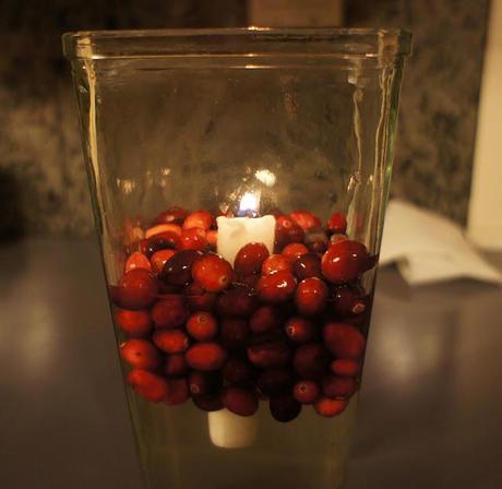 cranberries + water + candle + vase