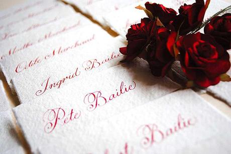 Rustic wedding place cards in red calligraphy