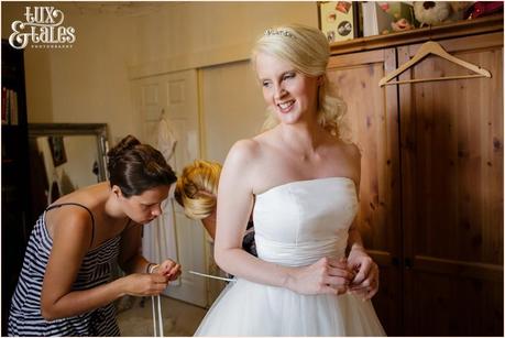 Bride preparation photography RSC Swan Theatre Wedding Photographer bride getting into dress