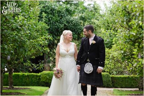 East Riddlesden Hall Wedding Photography pink English garden theme | Walking in gardens