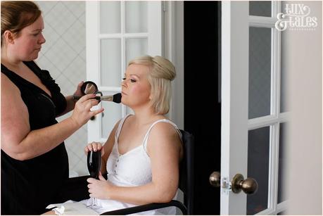 Bride Preparation photography East Riddlesden Hall wedding photographer makeup applied with blusher brush