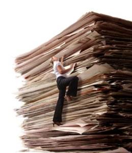 Business Woman Climbing a Pile of Files