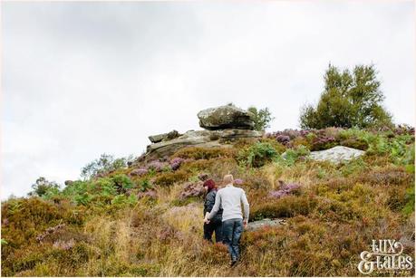 Rocks int he Heather | Walking holding hands | Brimham Rocks Engagement Photographer in North Yorkshire | Tux & Tales Photography