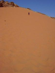 Therese climbs a sand dune at Wadi Rum