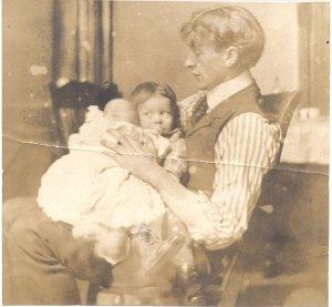The young father with his infant daughter, Pauline, and slightly older son, Linus. 1903.