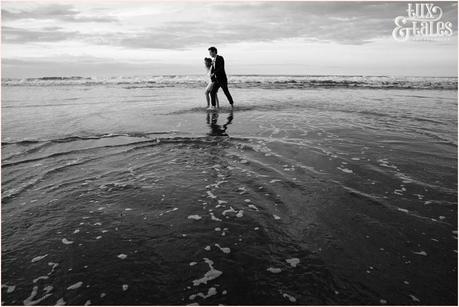 Whitby Love Shoot | Cass & Josh Photography Engagement Shoot in Whitby | Girl wearing Red Flower crown | Alterntive Couple whereing Vintage clothing |walking through the water