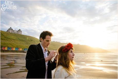 Whitby Love Shoot | Cass & Josh Photography Engagement Shoot in Whitby | Girl wearing Red Flower crown | Alterntive Couple whereing Vintage clothing | Man ties flower crown