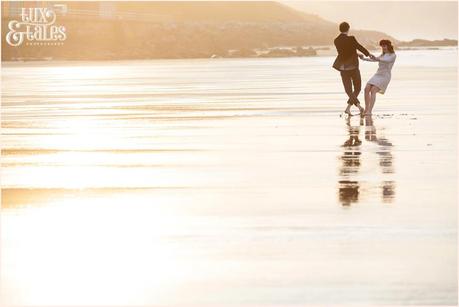Whitby Love Shoot | Cass & Josh Photography Engagement Shoot in Whitby | Girl wearing Red Flower crown | Alterntive Couple whereing Vintage clothing | Couple spinning with reflection on sand
