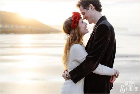 Whitby Love Shoot | Cass & Josh Photography Engagement Shoot in Whitby | Girl wearing Red Flower crown | Alterntive Couple whereing Vintage clothing | couple hugging in the sunset