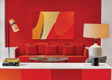 Every Room is a Different Hue in This Bright Manhattan Hotel Manhattan hotel room with orange and red walls and sofa