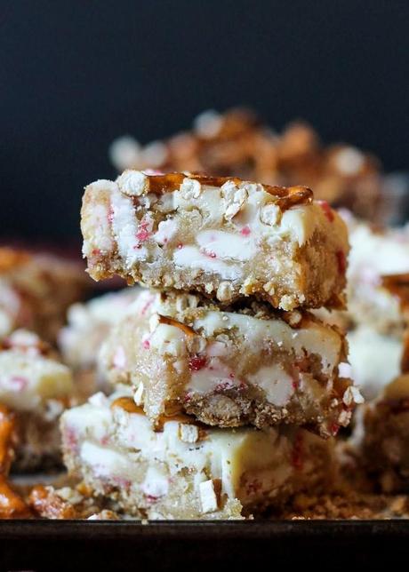These Peppermint White Chocolate Pretzel Bars have a salty-sweet pretzel crust, a sugar cookie-style bar that's loaded with peppermint and white chocolate, all topped with melted white chocolate and more peppermint!