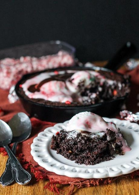 This Peppermint Skillet Brownie, loaded with chocolate, peppermint chips, and Candy Cane Kisses, is the perfect decadent treat to share with friends this winter! Best served warm with ice cream.
