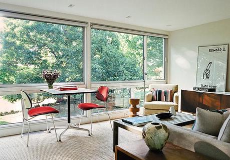 Modern guesthouse renovation in New York living room with Eames base table and plywood dining chairs by the window