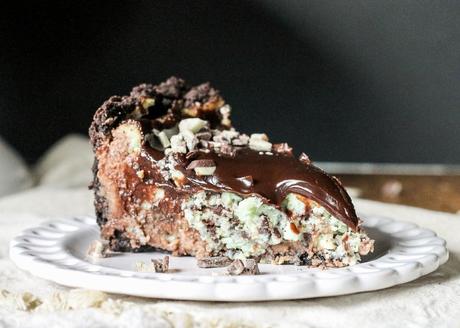 This Mint Chocolate Chip Cheesecake has a chocolate cheesecake layer topped with a minty green cheesecake layer on an Oreo crust. It's the perfect decadent holiday treat!