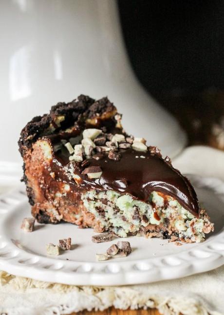 This Mint Chocolate Chip Cheesecake has a chocolate cheesecake layer topped with a minty green cheesecake layer on an Oreo crust. It's the perfect decadent holiday treat!