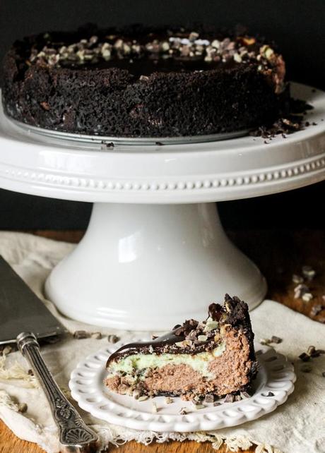 This Mint Chocolate Chip Cheesecake has a chocolate cheesecake layer topped with a minty green cheesecake layer on an Oreo crust. It's the perfect decadent holiday treat!