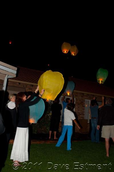 sky lanterns leaving outstretched hands