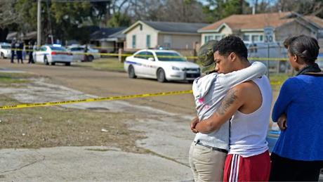 Advocate staff photo by HILARY SCHEINUK -- Two people console one another on the scene of a shooting death under investigation by Baton Rouge police the morning of Saturday, Jan. 10, 2015 at 4965 Jefferson Avenue near N. Foster Drive.