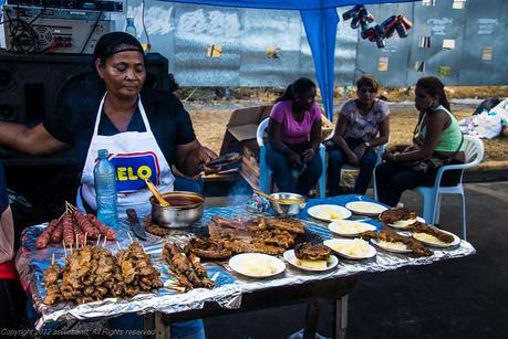Locals sell foods all along the street during Carnival
