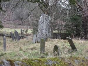 An old stone amongst the headstones