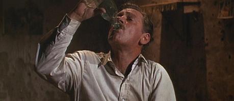 William Holden in The Wild Bunch Pike stocks up on liquid courage.