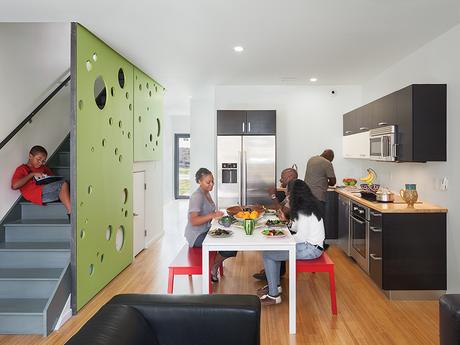 Modern affordable multifamily passive houses like the Belfield Avenue Townhomes in Philadelphia by Onion Flats wtih carbonized bamboo floors, fiberboard screen, bosch appliances, and induction cooktop