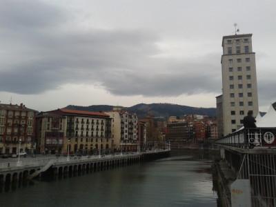 Backpacking in the Basque Country: Top 5 Sights in Bilbao Bilbao is built by a river and with mountains in behind.