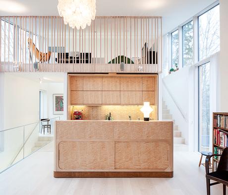 6 Ways to Use Wood in the Kitchen Modern home in Finland with sauna has custom birch cabinets and island in kitchen and a lofted family room