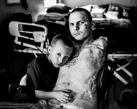Army Spc. Jerral Hancock sits for a portrait with his son Julius. It is believed that Hancock was trapped under the wreckage of his Army tank in Iraq for half an hour before he was rescued.