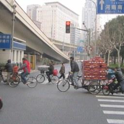 TRANSPORT IN SHANGHAI, CHINA. The beer delivery man gets a helping hand in Shanghai.
