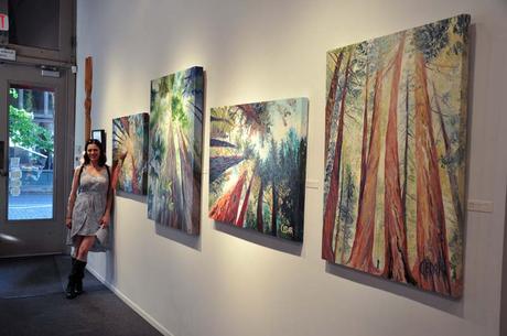 Portland, Oregon Artist Cedar Lee with her oil paintings of trees at Attic Gallery