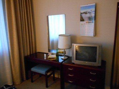 Staying at the 5 Star Yanggakdo Hotel in Pyongyang, North Korea Desk, mirror and TV