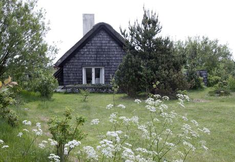 A cottage in Denmark with a traditional thatched roof