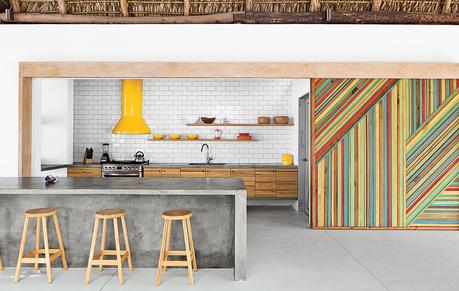5 Concrete Kitchens We Love modern beach house thatch roof kitsch concrete island sliding door