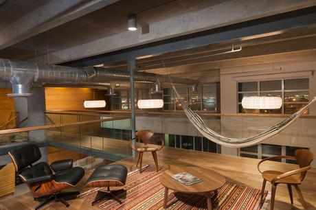 House of the Week: Major Loft Renovation in Miami Eames lounge chair and hammock in office of Miami loft renovation.