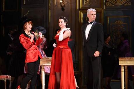 At Flora’s ball, Violetta (Lisette Oropesa) is back on the arm of the Baron (Daniel Mobbs)