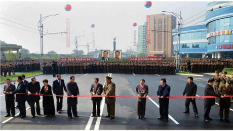 Members of the DPRK's central leadership, construction workers and scientists cuts a ceremonial red tape to open the Mirae Scientists' Street in Pyongyang on November 3 (Photo: Rodong Sinmun).