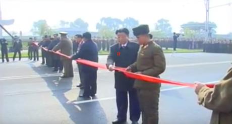 State Planning Commission Chairman and DPRK Vice Premier Ro Tu Chol (a) and a KPA construction service member cut a ceremonial red tape to open the street (Photo: KCTV).