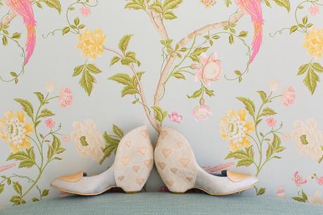 Irregular choice shoes in front of flowered wallpaper Langar Hall Wedding Photography