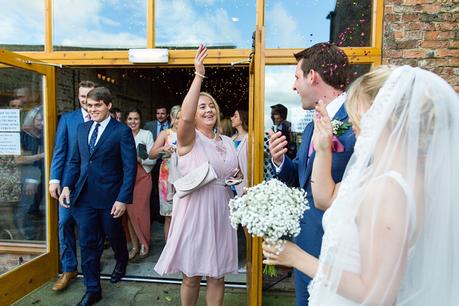Guest throwing confetti Barmbyfield Barn Wedding