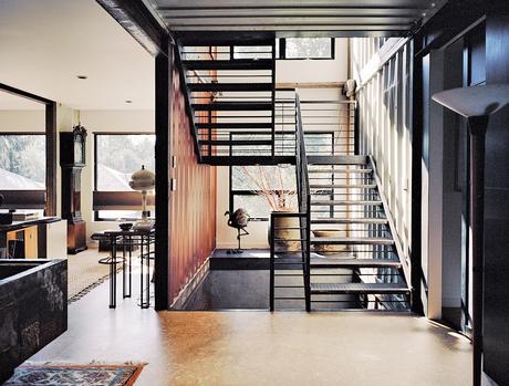 Industrially-styled stairway of shipping container home in Pennsylvania off the Delaware River