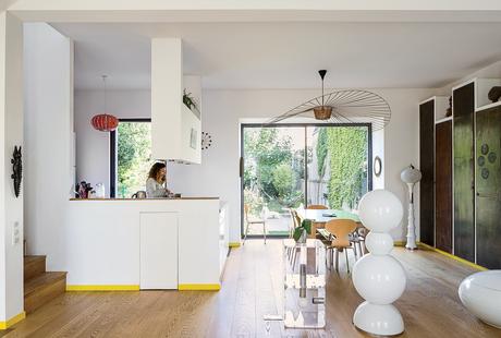 modern prefab home in Paris suburb with Vertigo lamp by Constance Guisset, Gijs Bakker strip table, and metal panels in the living area
