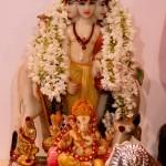 A statue of Lord Dattatreya decorated with flowers