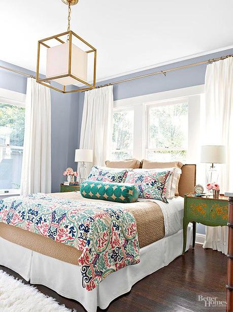 Bedroom Window Solid neutrals mixed with patterned accents and shapely antique nightstands make the perfect case for how wonderful mixing and matching can be.: