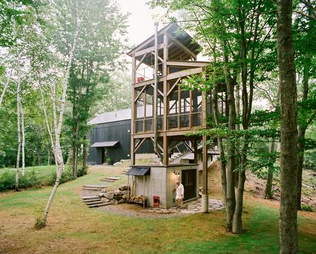A three-story tree house features a sauna and screened-in dining room.
