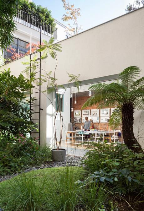 A 6,000-Square-Foot Creative Dreamworld Packed with a Tropical Garden, Neon Rooms, and More Custom table and vintage Wishbone chairs by Hans Wegner in Antwerp studio.