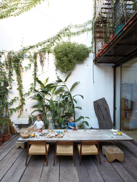 Children play with toys on a custom table with chairs designed by the architects. 